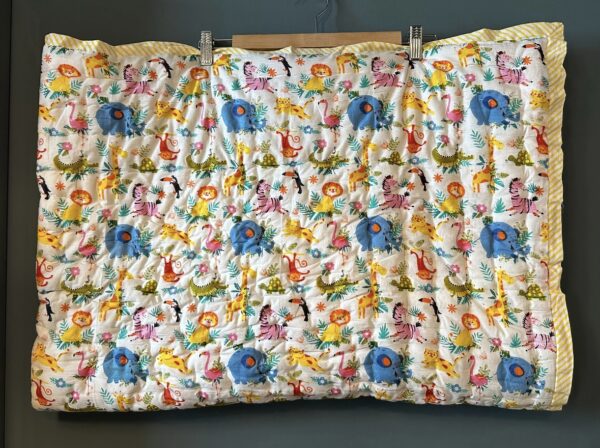 Children's quilt with a colourful jungle animals design