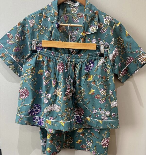 Teal short sleeved pyjama set with shorts in a plant design