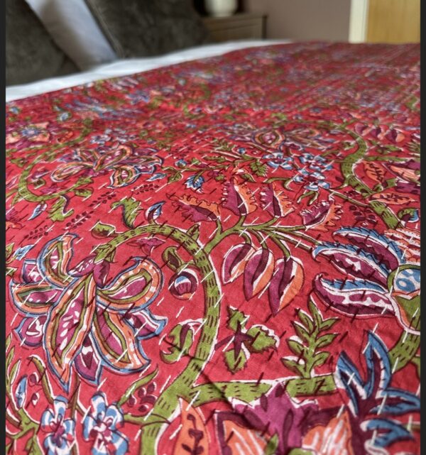 red quilt with floral design